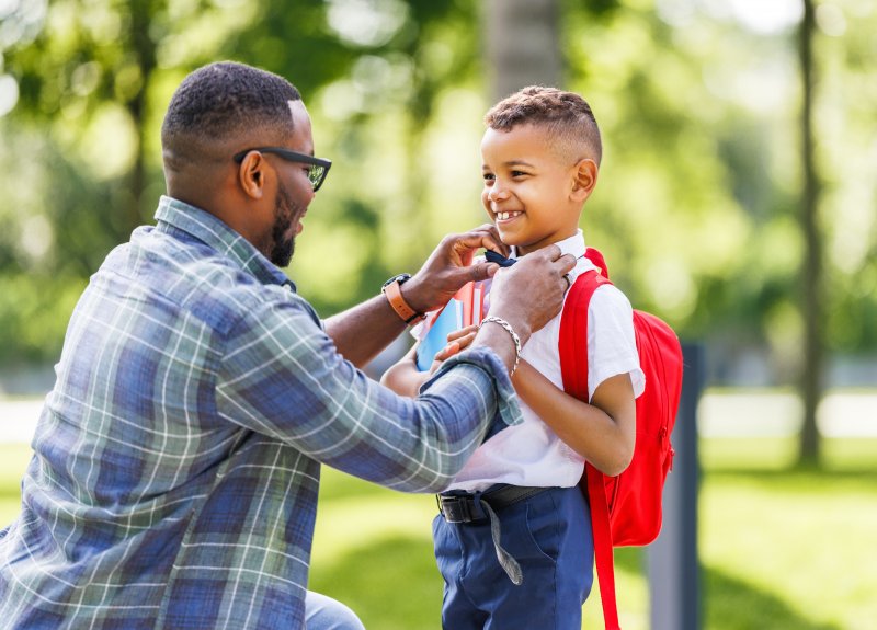 Dad gets son ready for school